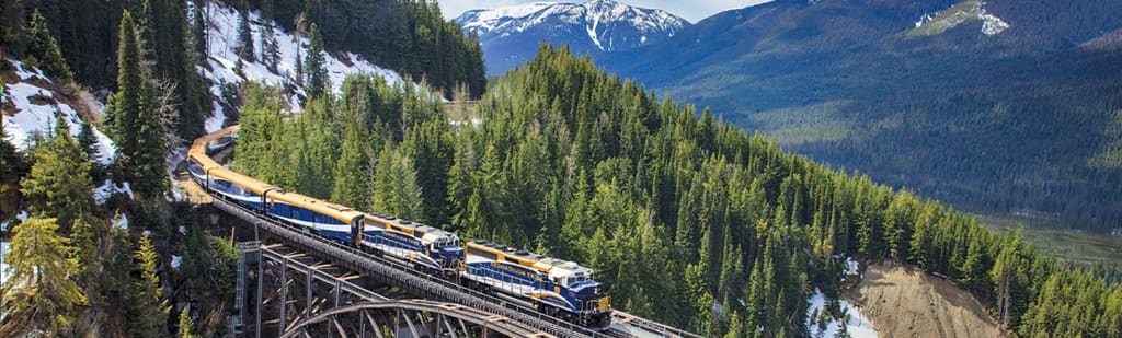 Journey on the Rocky Mountaineer  through the rugged terrain of the Canadian Rockies with a pre or post cruise land program to the Great Land.