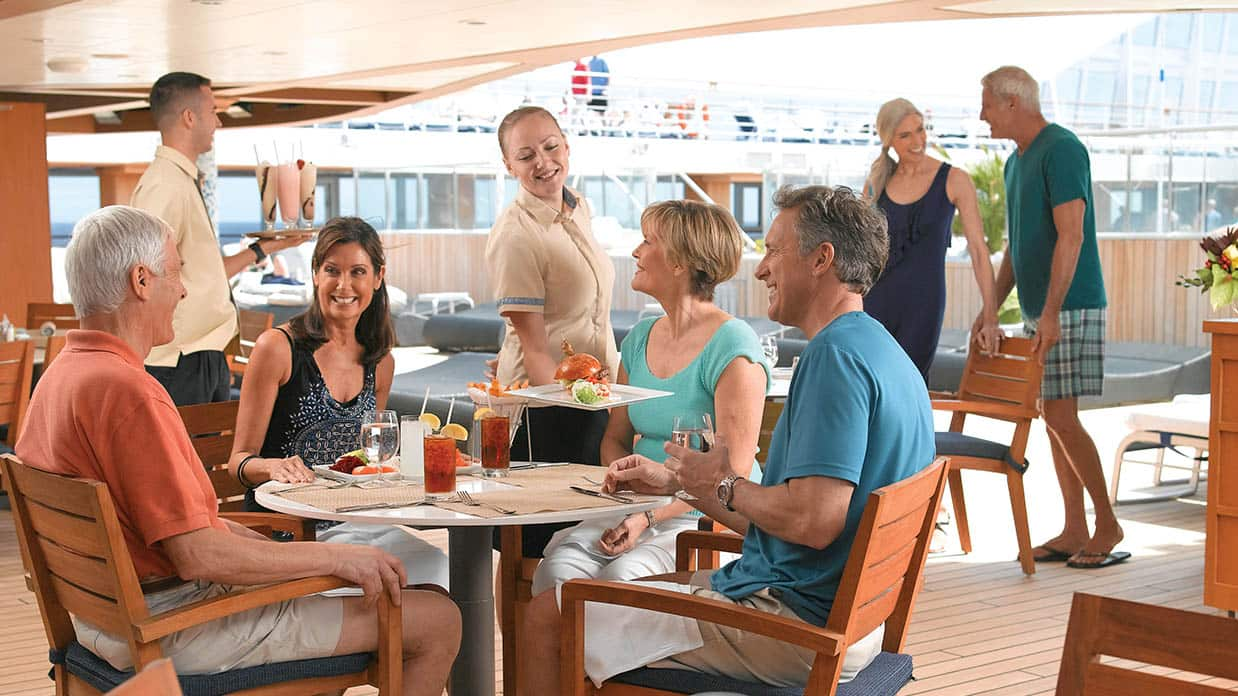 Friends enjoying a meal at Waves Grill on board Marina