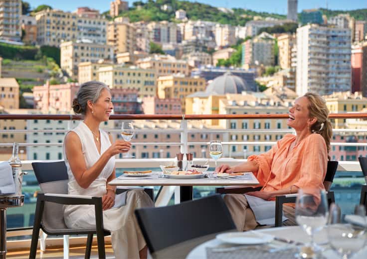 Oceania Cruises Your World Included amenities. Ladies having wine with lunch onboard at Terrace Cafe.